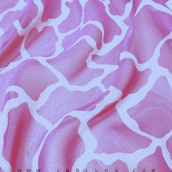 Pink giraffe-printed mulberry silk chiffon fabric with a sheer, flowing hand by JB Silks.